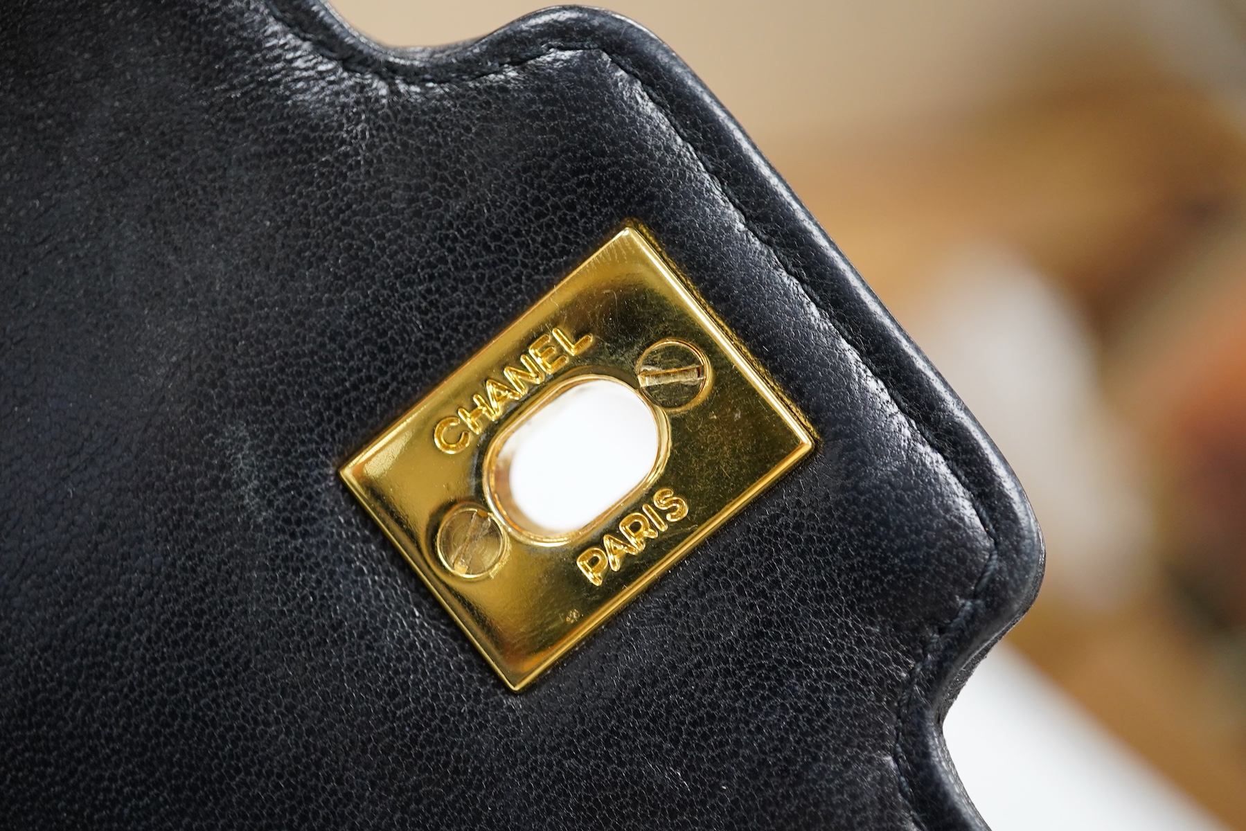 A late 1980’s Chanel black leather Diana shoulder bag with original dust cover and bag, Chanel authenticity card numbered 1944645, interior date code rubbed, 23cm wide, Provenance: Purchased by the vendor, 26 Old Bond St